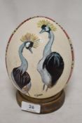 A vintage Ostritch egg having been hand decorated with an Emu design.