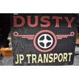 A vintage advertising board for Dusty JP Transport.