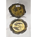 Two antique Japanese mixed metal dishes embossed with designs of two carp swimming and a pair of