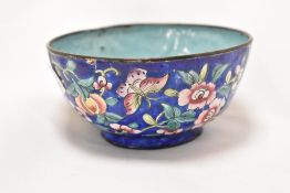 A small enamel bowl in a Chinese style being hand decorated with fruit and flower scenes 9cm wide.