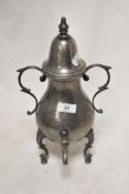 An early 20th century pewter samovar tea pot in a Gothic design on tripod base.