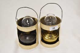 An unmatched pair of miniature oil lamps with folk art style can holders.