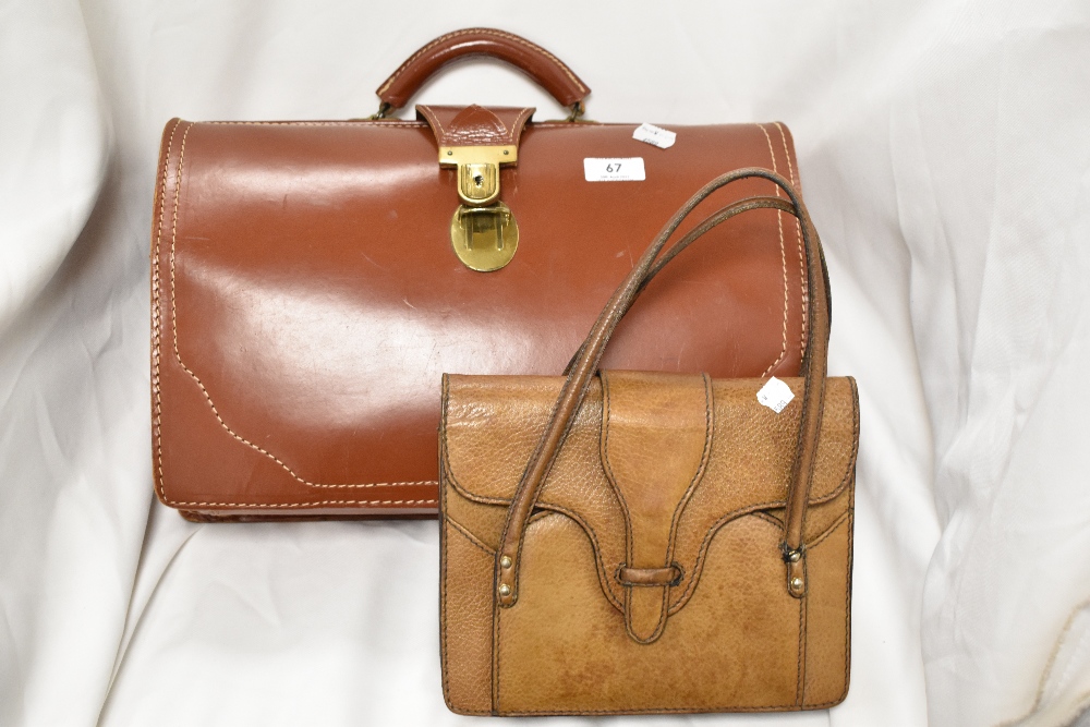 A vintage leather Gladstone style bag with a similar leather handbag.