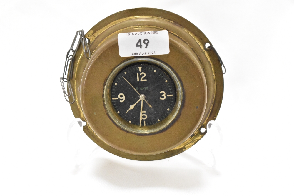 An early 20th century dashboard clock with brass case possibly aviation or motor related.