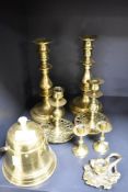 Three pairs of antique brass candlesticks with a chamber stick and condiment container.
