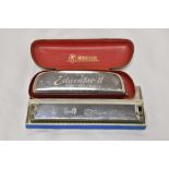 A vintage Hohner Educator II harmonica in original case and a Chinese Tower harmonica