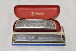 A vintage Hohner Educator II harmonica in original case and a Chinese Tower harmonica