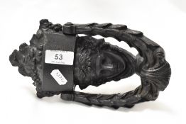 A Victorian cast iron door knocker in the form a maiden with fruit basket and a laurel wreath