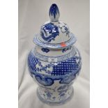 A large floor standing Chinese urn having printed blue and white ware design with lid in very fine