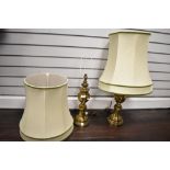 A vintage pair of brass baluster lamp bases with appropriate matching shades. Lamp bases measure