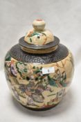 A large reproduction Chinese ginger jar decorated in crackle glaze famille vert with scenes of