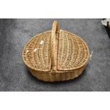 A vintage picnic hamper in wicker cane. 54cm long.