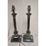 A pair of early 20th century silver plated lamp bases in the form of classical styled candlesticks.
