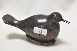 A 20th century lapidary study of a seabird on nest, carved in a green and red stone.
