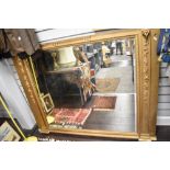 A large Victorian over mantel mirror framed by two column supports adorned with rams heads and fruit