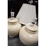 Two large modern ceramic lamp bases in a cream glaze.