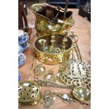 A selection of vintage brass wares including coal bucket, candlesticks, chestnut roaster and fire