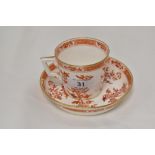 A Victorian Minton tea cup and saucer set in a red and gilt design, saucer having hair line cracks.