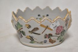 A small porcelain fish style bowl decorated with scenes of insect life.