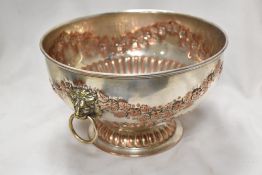 An early 20th century silver plated punch bowl with lion head handles and impresses floral boarder.