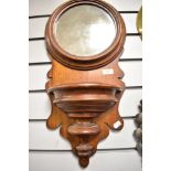 A late Victorian Mahogany hallway mirror in an ecclesiastical design with pocket shelf and formed