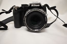A Nikon Coolpix P100 digital camera with Nikkor 26x wide optical zoom ED VR 4,6-120mm 1:2,8-5,0