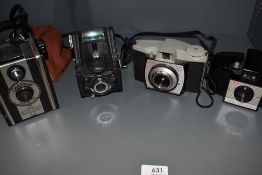 Four cameras. An Ensign Ful-Vue, a Coronet Twelve-20 box camera, a Kodak Brownie 127 and a Brownie
