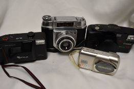 Four cameras. A Fuji DL10 Compact, and Olympus Stylus 410 Digital, a Canon Sureshot 105 and a Halina