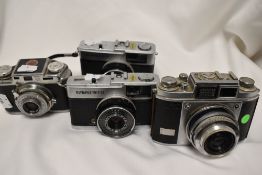 Four cameras. A Bolsey Model B2 with Wollensak 44mm f3,2 lens, two Olympus Trip 35, and Balda with a
