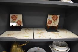 Two sets of early 20th century tiles hand painted with scenes of country garden roses.