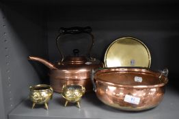 A selection of antique copper and brass wares including solid cast brass trivet, stove kettle and