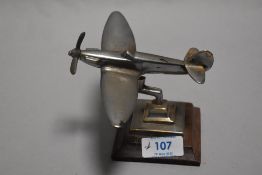 A small model of an RAF Spitfire aeroplane cast in copper and chromed, stamped to base 1945 GHC