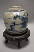 An 18th century Japanese ginger jar decorated with blue and white design, having crack to base and