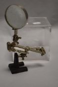 A jewellery makers or similar microscope with adjustable clamps.