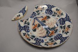 An 18th century delft charger having typical Chinoiserie pattern in an Imari style palette. 34cm