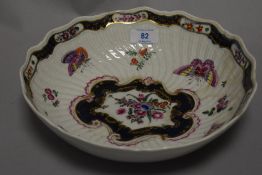 A first period Worcester bowl having scalloped form with butterfly and moth decoration. Having