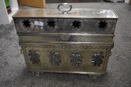 An early 20th century Edwardian silver plated cased four bottle tantalus having chase work of vine