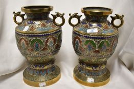 A pair of oriental antique cloisonne mantel urns.