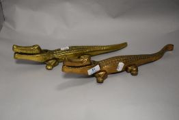 A pair of mid century heavy cast brass crocodile form nut crackers.