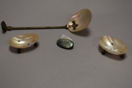An early 20th century table salt serving set in mother of pearl with a silver and carved shell