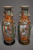 A pair of 19th century Chinese export porcelain vases in famille rouge decorated with a couple