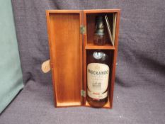A bottle of Knockando 12 Year Single Malt Scotch Whisky, distilled in 1991, 43% vol, 70cl, in wooden