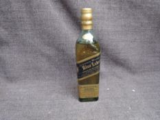 A small bottle of Johnnie Walker Blue Whisky Blended Whisky, bottle no Q440997, 43% vol, 20cl