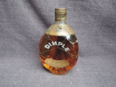 A bottle of John Haig & Co Ltd Dimple Old Blended Scotch Whisky having dpring top, 70 proof , no