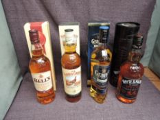 Four bottles of Blended Scotch Whisky, The Famous Grouse, Bell's 8 Year Old, Grant's Signature and