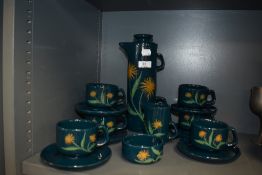 An attractive modern Craw Arran studio pottery coffee set, decorated with stylised flowers against a