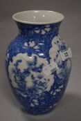 A 20th Japanese porcelain baluster vase, transfer-printed in blue with shaped floral vignettes