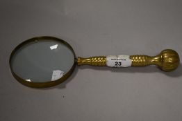 A brass and Mother-of-Pearl magnifying glass, of traditional design