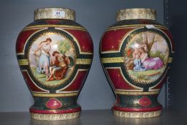 A pair of large Royal Vienna type porcelain urns, decorated with figural vignettes signed