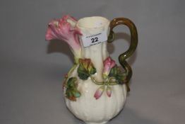 A late 19th century porcelain jug, the handle and spout formed as naturalistic foliage, painted 35